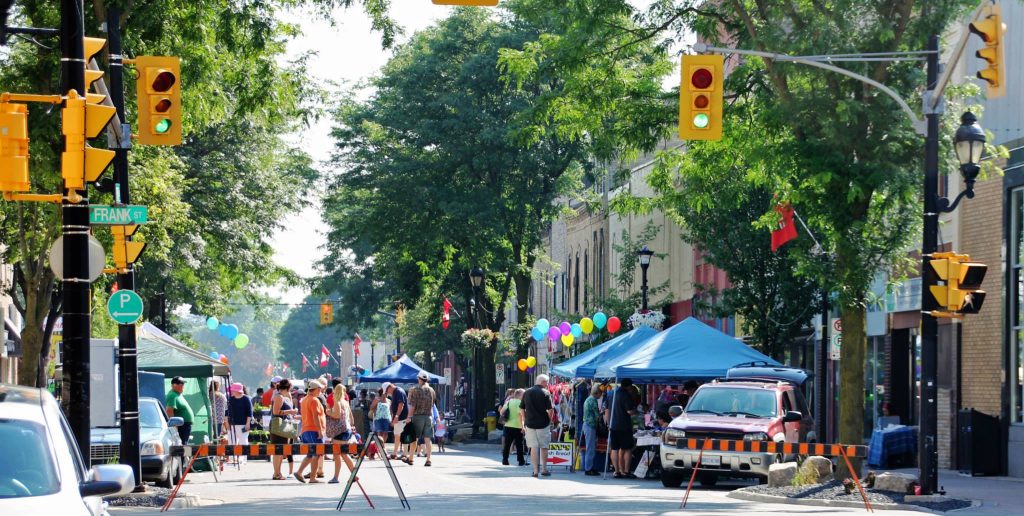 A small downtown street closed off for a farmers market.